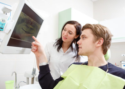 Patient and dentist looking at screen with dental results.